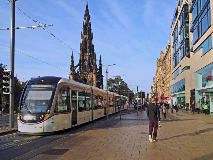 A tram on the Edinburgh tram network passing through Prince Street. Credit: Pete Spiro/Shutterstock.