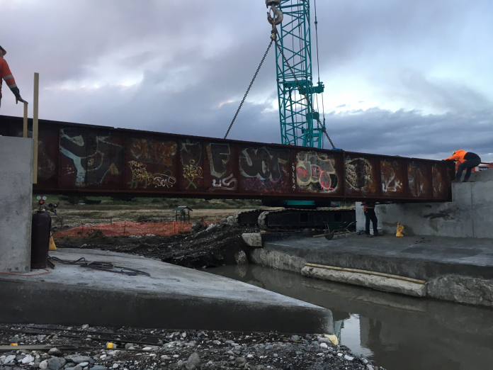 KiwiRail said that speed has come before beauty in the rebuild effort. Pictured above is Bridge 131, near Wharanui, a replacement bridge that has been made from used steel spans - including the graffitied one shown above. Credit: KiwiRail.