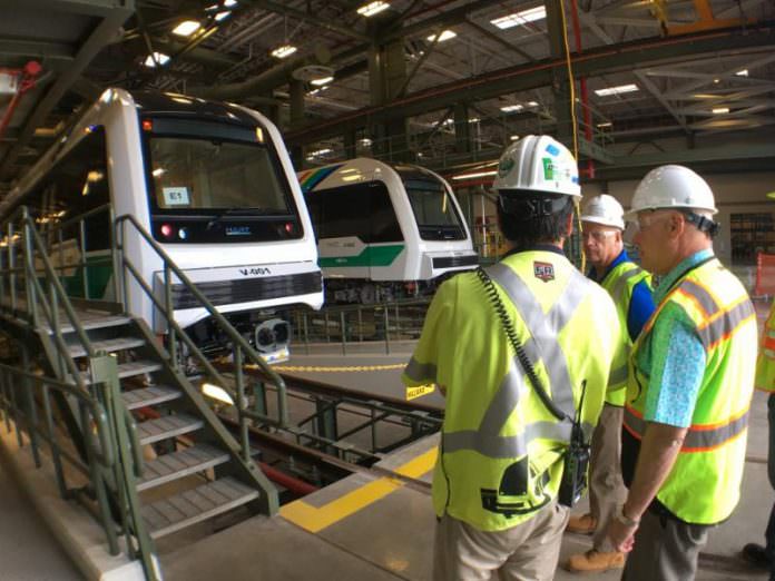 New HART CEO Andrew Robbins (far right) inspects rail cars at the rail operations centre. Credit: HART.